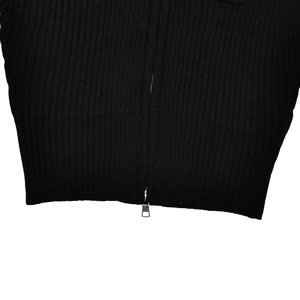 Detail of the black ribbed knit fabric and silver metal zipper on the slim fit sweater