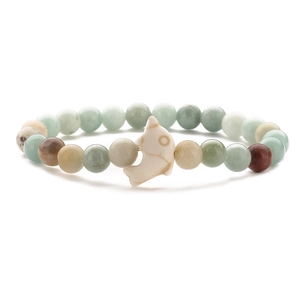 Elastic beaded bracelet with mixed natural stones and a white dolphin pendant
