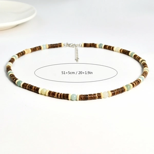 Detailed shot of brown coconut shell bead necklace with adjustable lobster clasp and size info
