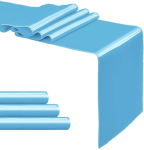 Detail of light blue satin table runner with glossy silk texture and refined stitching