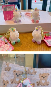 Macro detail of cartoon unicorn keychains with woven texture and matching straps