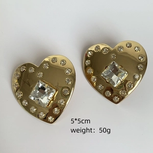 Detailed view of large gold heart earrings with square crystal and size markings
