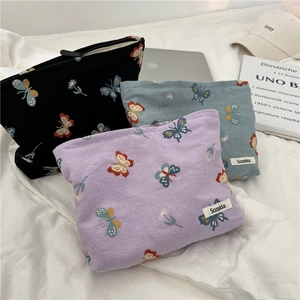 Sky blue embroidered butterfly makeup bag with floral patterns and zipper closure