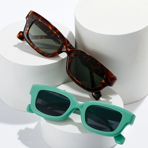 Retro rectangle square sunglasses in tortoiseshell and mint green on display stands