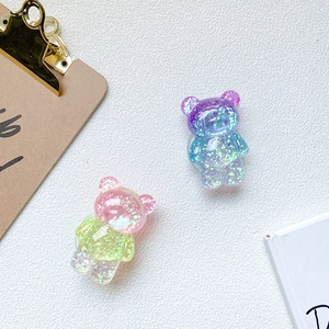 Gros plan de supports ours pour téléphone avec paillettes et dégradés de couleurs