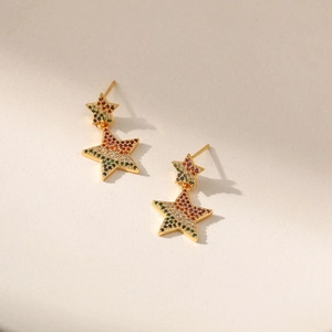 Detail of star drop earrings with 18K gold plating and colorful pavé cubic zirconia