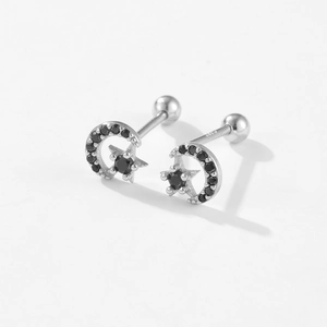 Macro detail of S925 silver star and moon earrings with black zircon and screw back
