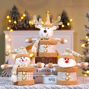 Three festive Christmas candy jars with snowman, reindeer, and Santa plush characters
