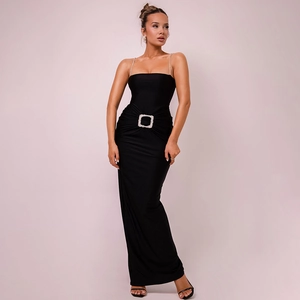 Detail of elegant black maxi dress featuring thin straps and sparkling rhinestone buckle