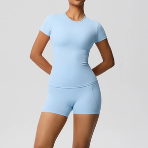Detail of light blue brushed nylon yoga set with tight short sleeve top and high waist shorts