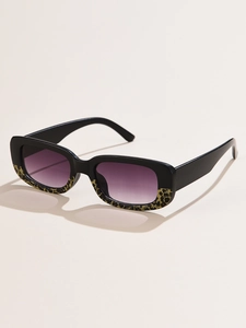 Detail of vintage rectangular sunglasses with black and leopard frames and purple gradient lenses