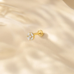 Detailed macro shot of an octagon gold stud earring with S925 engraving and zircon inlay