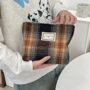 Detail shot of vintage plaid cosmetic bag with stitched Pleasant Time fabric label