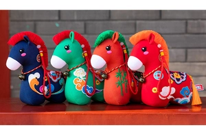 Detailed view of four colorful Chinese folk style plush horse toys with intricate embroidery.