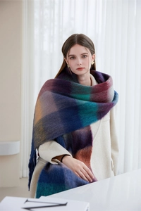 Detail of soft plush oversized scarf featuring a colorful purple and blue checkered pattern