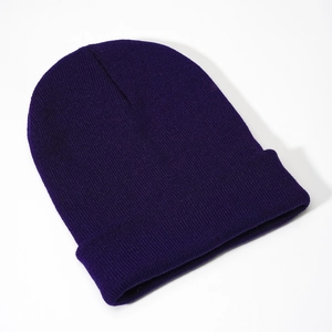 Detailed close-up of dark purple knit beanie texture with a classic folded cuff edge