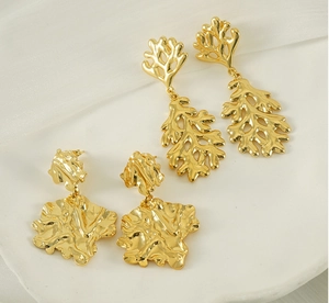 Detailed macro view of 18K gold plated irregular lava leaf earrings with coral texture