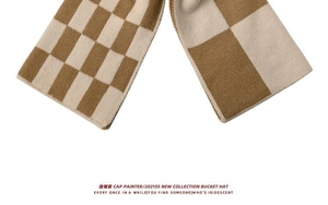 Detail of soft khaki checkerboard knit scarf texture with warm wool blend fabric