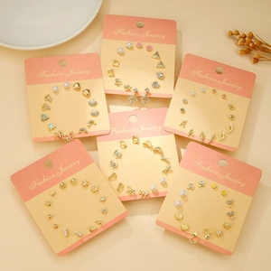 Golden titanium steel stud earring set featuring stars moons pearls and bow designs