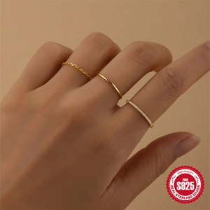 Elegant gold S925 sterling silver minimalist ring set with small zircon stones on finger