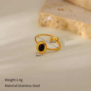 Detail of a gold adjustable stainless steel ring featuring a black oval natural stone
