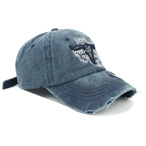 Close-up of vintage washed denim baseball cap with Texas bull skull embroidery and frayed brim