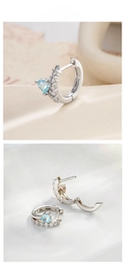 Macro detail of silver heart hoop earrings with light blue zircon and micro-pave crystals