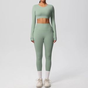 Close-up of high-waist yoga leggings and long sleeve crop top in sage green