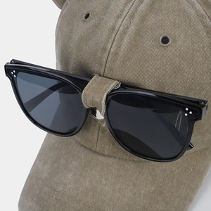 Close-up of retro washed cotton baseball cap with integrated pilot sunglasses detail