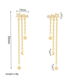 Macro detail of long tassel star and moon earrings with dimensions and weight info