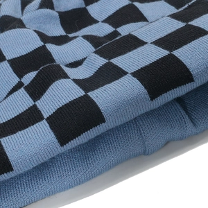 Macro view of blue and black checkerboard knit pattern with ribbed edge detail