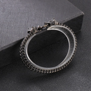 Detail of hip hop double wolf head stainless steel bracelet with textured link chain