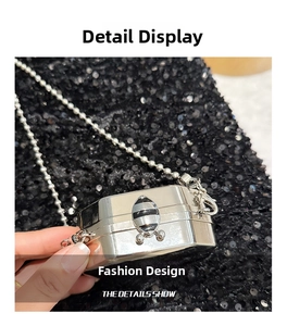 Detail of silver metallic mini bag with bee clasp and silver bead chain strap