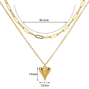 Close-up of 18k gold layered paperclip necklace with heart pendant and dimensions