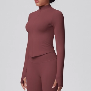 Detail of burgundy sports jacket sleeve with thumbhole and high-stretch fabric texture