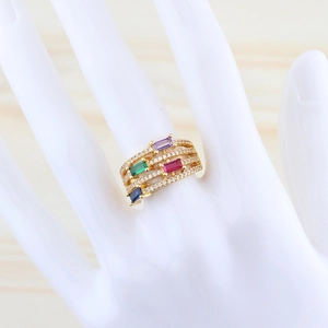 Detail of multi-layer gold plated ring with square rainbow gemstones and pavé crystals
