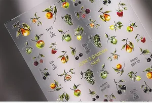 Macro view of 5D embossed fruit nail stickers featuring Josie's Garden theme