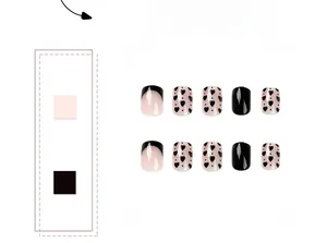 Macro detail of French black tip press-on nails with heart and polka dot patterns