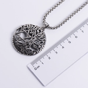 Classic Viking Tree of Life round pendant in silver stainless steel on white background