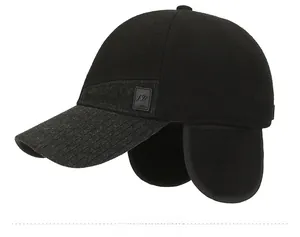 Side view of winter baseball cap for men with ear flaps and knit textured brim detail
