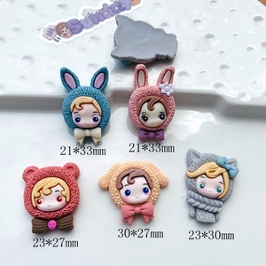 Flat lay of cartoon resin animal charms with size markings for DIY phone case crafts