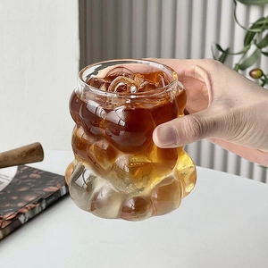 Minimalist heat-resistant glass coffee cup with unique irregular bubble design and handle