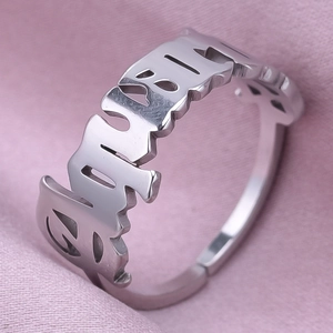 Macro detail of gothic style cutout GIRL letter ring in polished 304 stainless steel