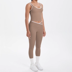 Detail of high-waisted yoga pants featuring a white V-cross waist design in mocha brown
