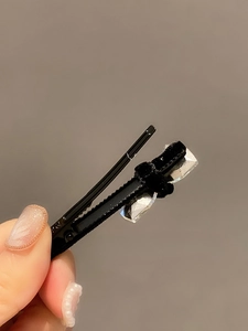 Elegant black velvet bow hair clip with sparkling crystal cubes for a stylish hair look