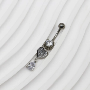 Gros plan sur piercing de nombril en argent avec zircons clairs en forme de coeur