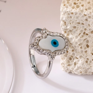 Silver Hamsa Hand ring featuring sparkling zircon pavé and blue Evil Eye centerpiece