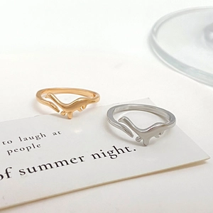Detail view of cute dinosaur open rings in gold and silver finish on display card