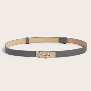 Detailed view of grey slim belt featuring a gold rhinestone-encrusted swivel lock buckle