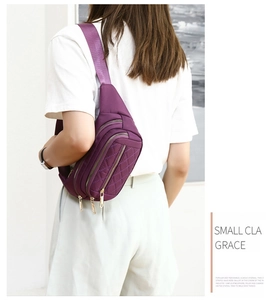 Rear view of purple quilted nylon waist bag with gold zippers worn by a model